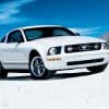 White 2006 Mustang V6 on desert road