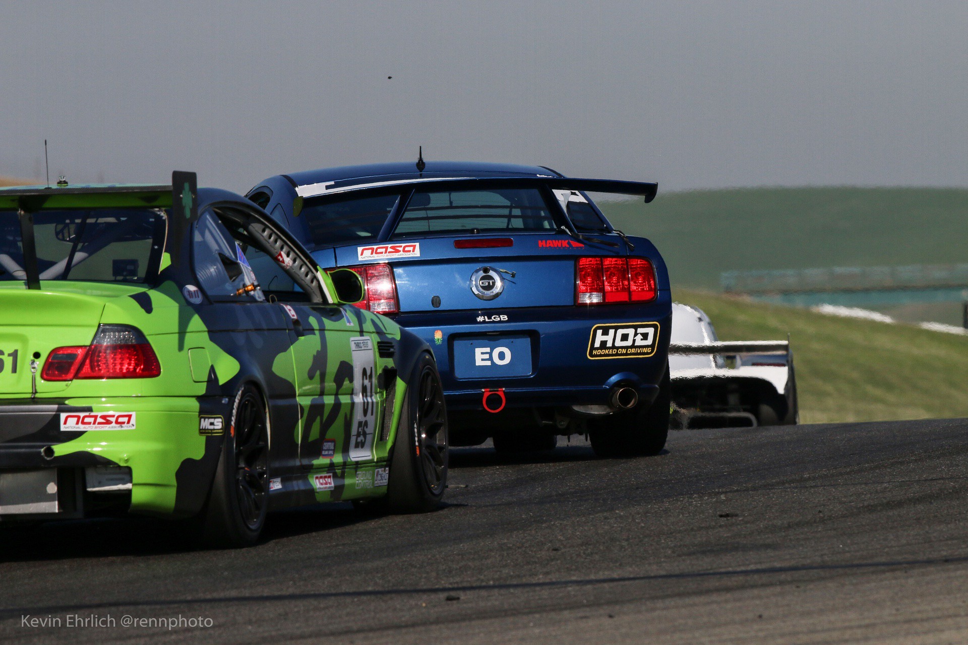 Rear view of 2008 Ford Mustang packed together with other cars at Thunderhill 2021