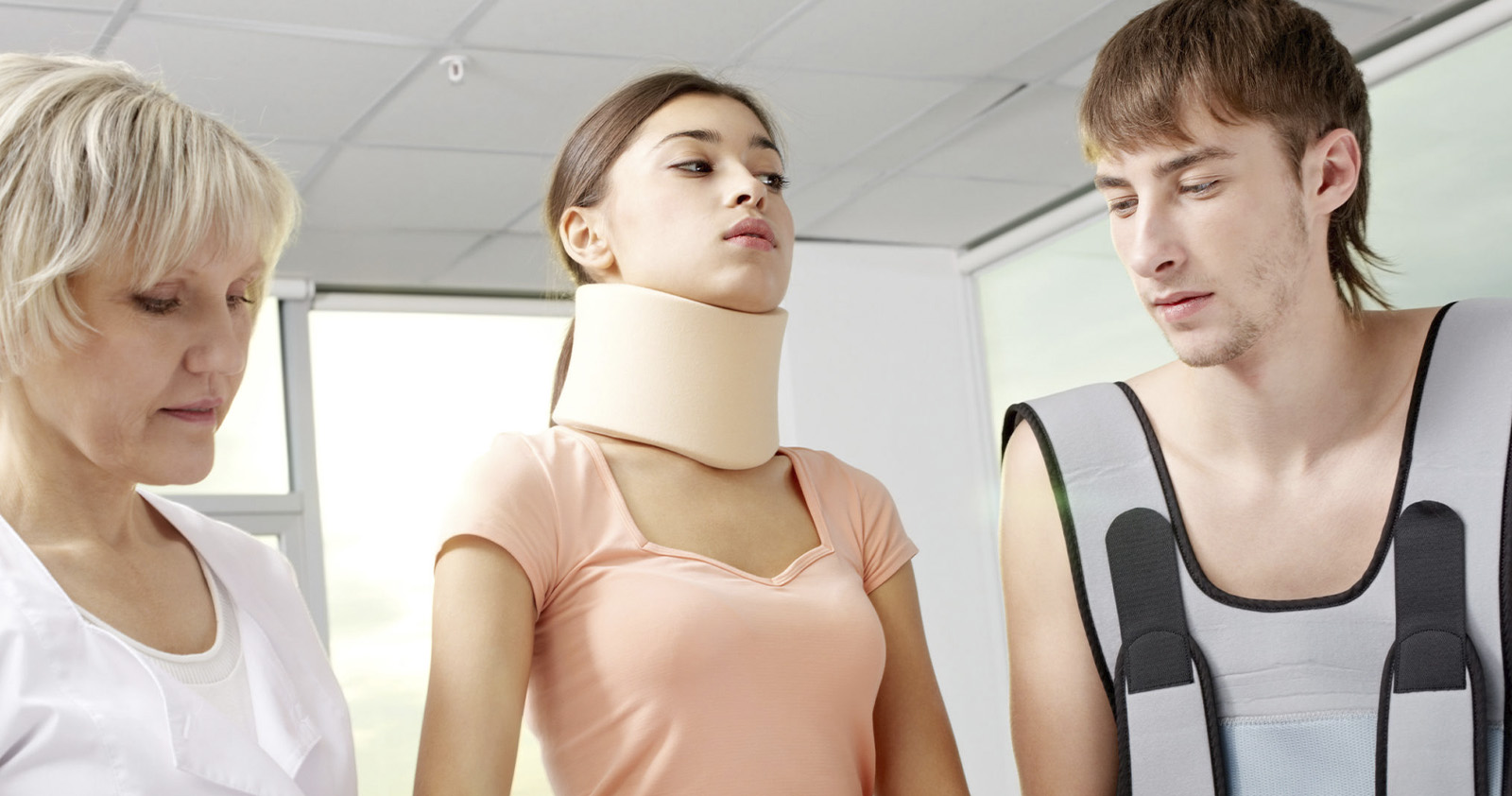 Girl in a neck brace receiving medical care
