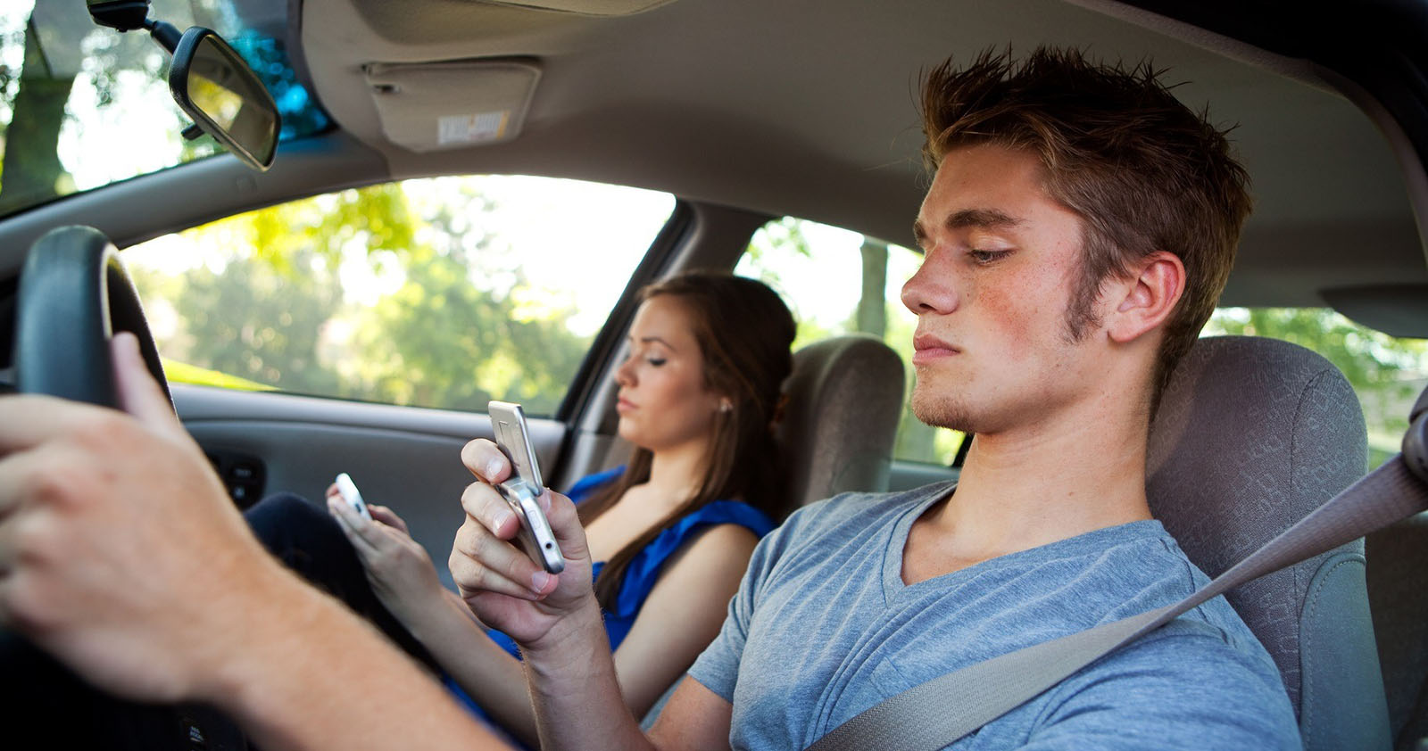 Man and woman texting while driving