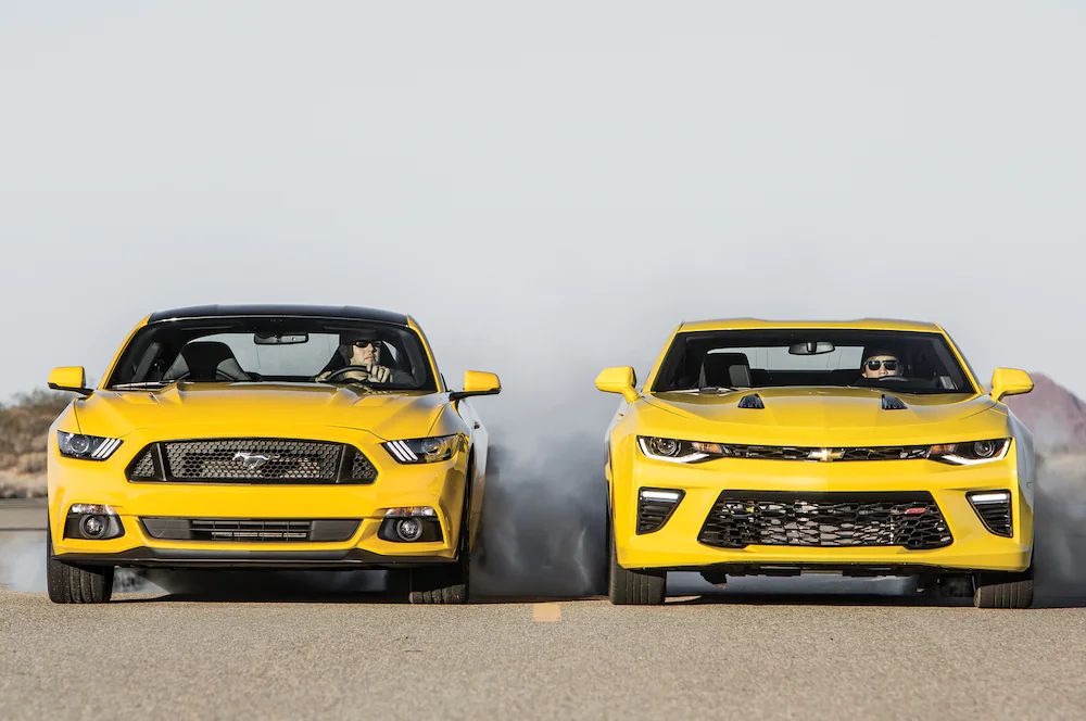 yellow Ford Mustang and Chevy Camaro