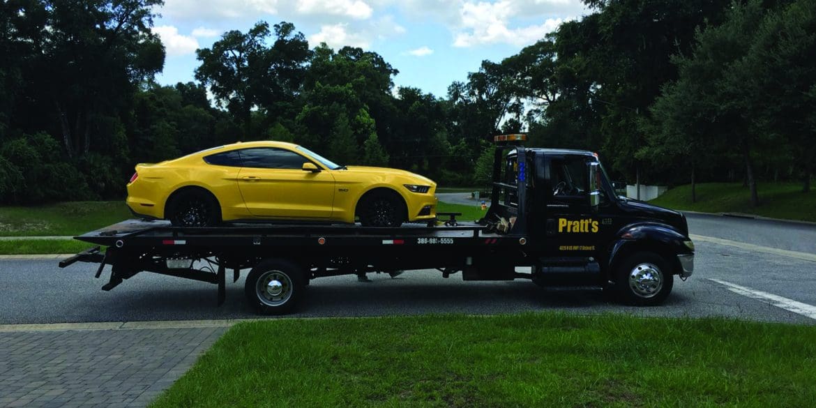 Yellow Mustang on flatbed truck