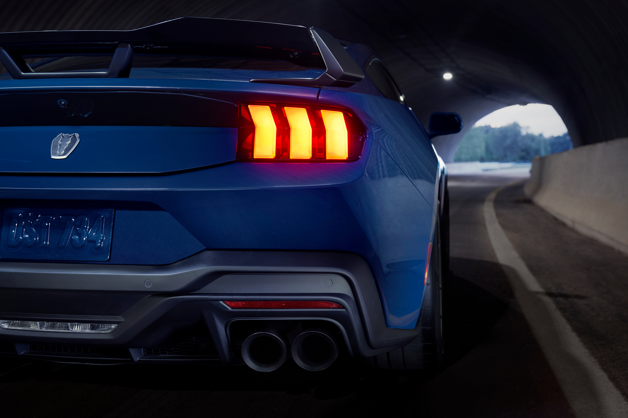 rear view rear end view with spoiler of mustang dark horse in tunnel