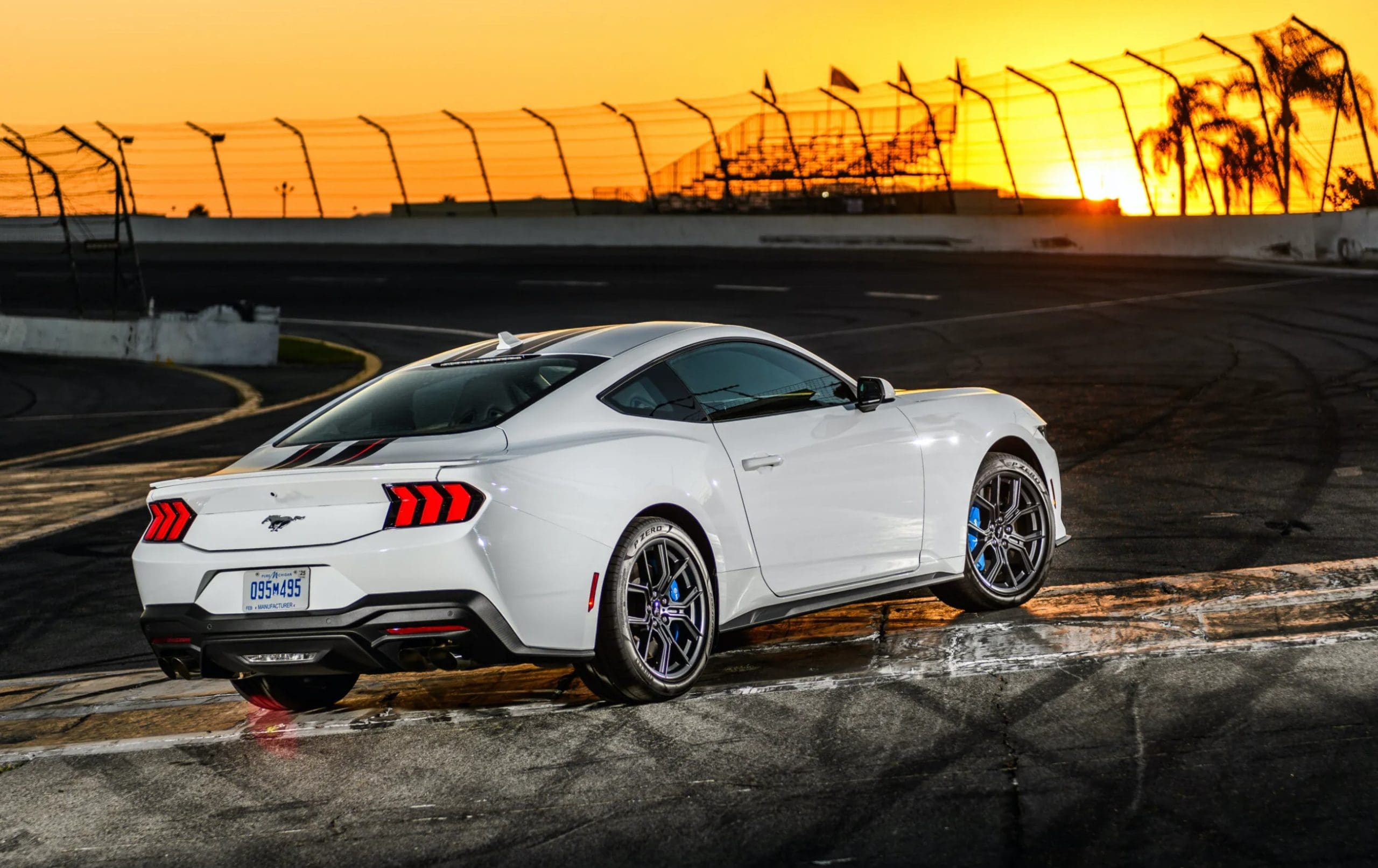 mustang ecoboost on race track parked at angle with sunset in front of it